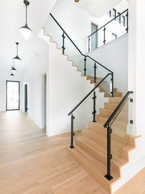 Staircase and adjoining floor featuring premium hardwood flooring, demonstrating the cohesive and elegant design achieved with our hardwood products.