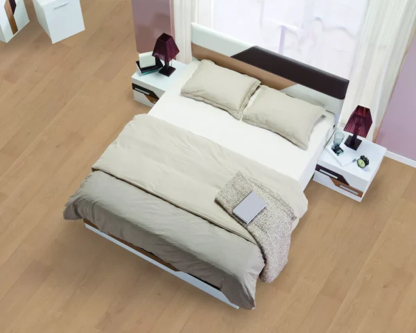 Alimia hardwood flooring in a modern bedroom, featuring natural wood planks beneath a neutral-toned bed.