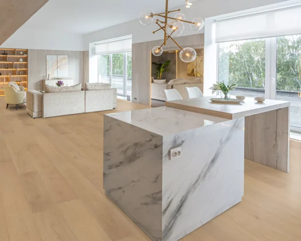 Alimia hardwood flooring in an open-plan dining and living area, featuring a marble kitchen island and modern decor.